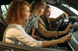 © alfa27 - caucasian family checking and examining new car from inside. they came with daughter to get new auto in dealership