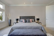 Master bedroom interior with king size bed. Luxury American modern home.