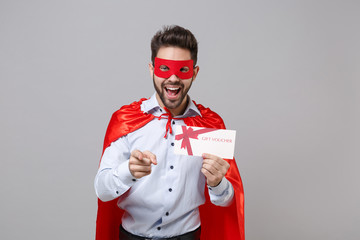 Canvas Print - Funny powerful business man in shirt superhero suit have supernatural abilities isolated on grey background. Achievement career concept. Real hero defend you. Hold gift certificate pointing on camera.