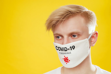 Wall Mural - Portrait of a man in a protective face mask with the inscription 