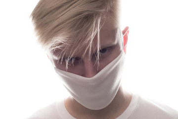 Wall Mural - Man wearing face protective mask on face against Coronavirus isolated on white.