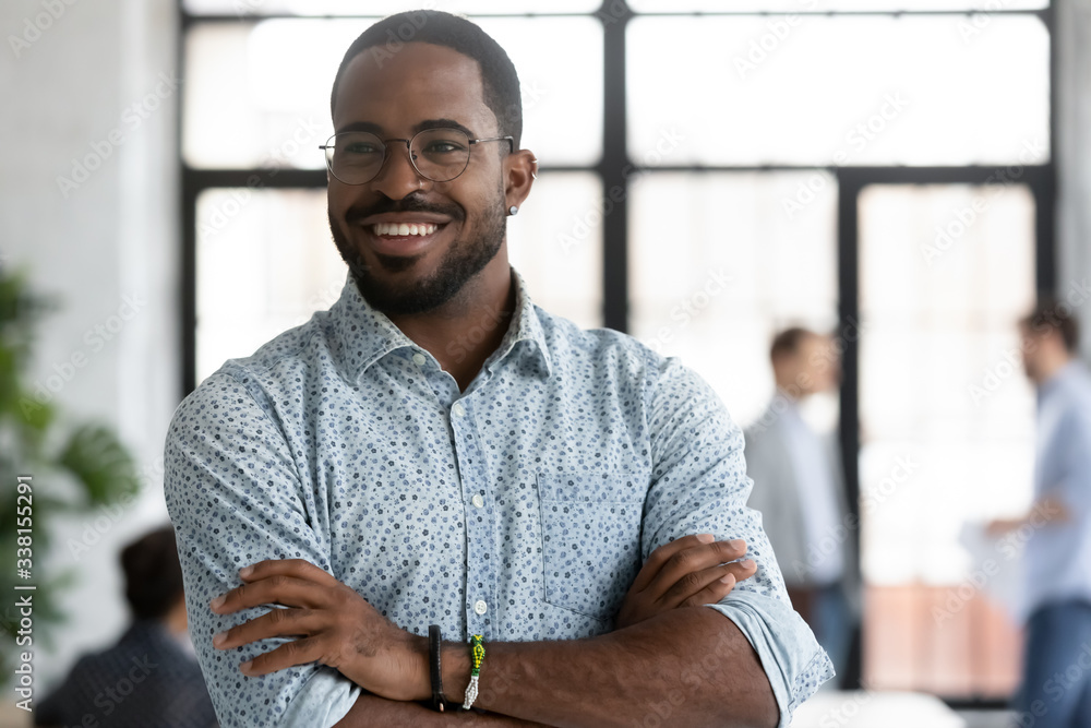 Happy motivated African American businessman in glasses look away thinking or pondering, smiling biracial male employee lost in thoughts consider career opportunities, business vision concept - obrazy, fototapety, plakaty 