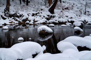 Wall Mural - view of snow covered rocks in stream