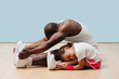 © zzzdim - Father and his little daughter stretching knees and backs on the floor