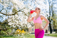 Fit Woman Having Break From Outdoor Exercise In Spring