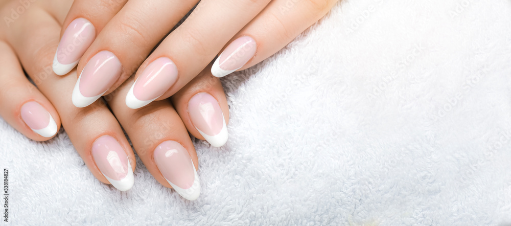 Manicure and Hands Spa. Beautiful Woman hands closeup. Manicured nails and Soft hand skin wide banner. - obrazy, fototapety, plakaty 