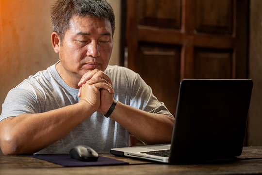 Christian men praying and working at home