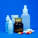 Fototapeta  - Medicine bottles with pills on a blue background.