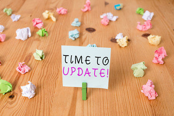 Wall Mural - Handwriting text Time To Update. Conceptual photo this is right moment to make something more modern new Colored crumpled papers empty reminder wooden floor background clothespin