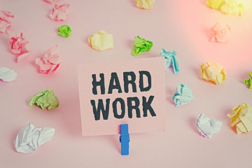 Wall Mural - Text sign showing Hard Work. Business photo showcasing always putting a lot of effort and care into work or endurance Colored crumpled papers empty reminder pink floor background clothespin