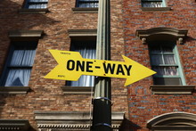 Low Angle View Of One Way Sign Outside Building