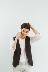 Wall Mural - Handsome asian man using mobile over white background.