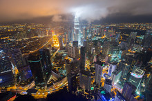 Petronas Towers Amidst Illuminated Cityscape Against Sky At Night