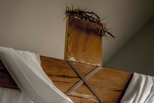 Low Angle View Of Wooden Cross With Spiked Crown Against Ceiling
