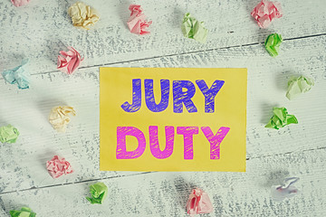 Conceptual hand writing showing Jury Duty. Concept meaning obligation or a period of acting as a member of a jury in court Crumpled rectangle squared paper reminder white wood desk