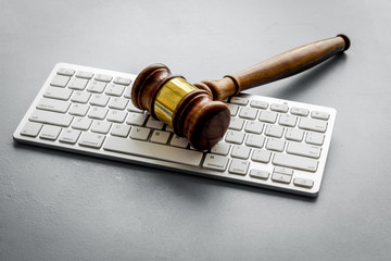 Wall Mural - Gavel on laptop keyboard - Justice, law - on grey table