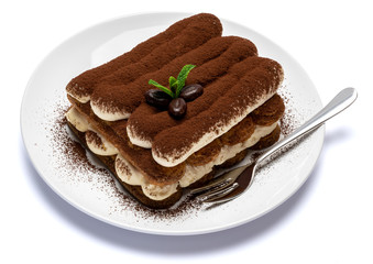 Classic tiramisu dessert on ceramic plate isolated on white background with clipping path