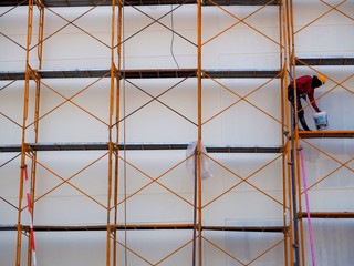 Man Working on the Working at height on construction site with blue sky