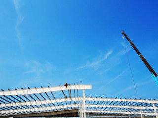 Man Working on the Working at height on construction site with blue sky