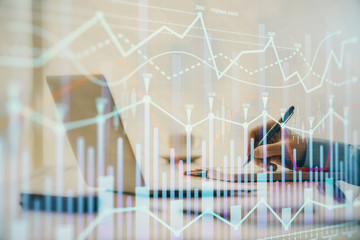 Double exposure of forex chart with man working on computer on background. Concept of market analysis.