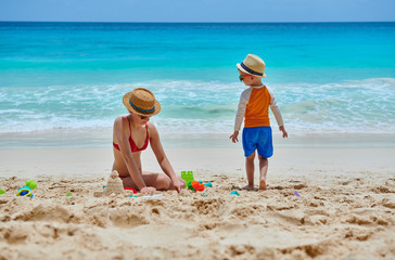 Wall Mural - Toddler boy on beach with mother