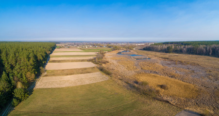 Rural landscape, aerial view. View of plowed and green fields in early spring. Panorama from 9 images