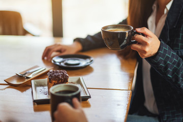 Canvas Print - Closeup image of women enjoyed eating dessert and drinking coffee together in cafe