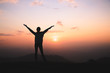 © Tinnakorn - Copy space of silhouette woman raise hand up on top of mountain and sunset  background. Freedom feel good and travel adventure holiday concept. Religious beliefs