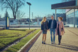 © Aleksandr - Love triangle. Handsome man embrace his two girlfriend and walks in the city.