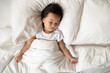 © fizkes - Asian little kid girl sleeping in bedroom on bed lying under warm duvet on comfortable mattress, top above view. Healthy peaceful sleep. Ad of high-quality diapers, great overnight protection concept