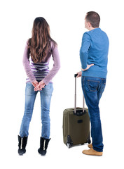 Poster - young couple in sweater traveling with suitcas.