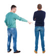 © ghoststone - Back view of two man in sweater pointing.