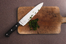 Food Ingredients, Parsley Herb Roughly Chopped On Chopping Board Next To Big Knife