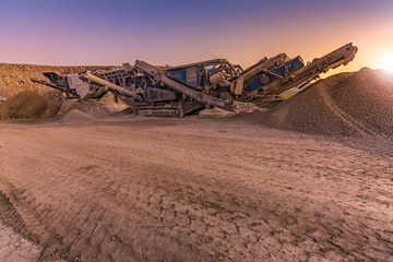 Excavator collecting stone in an open-cast mine