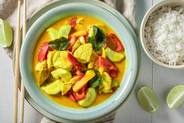 Wall Mural - Fresh yellow curry with kaffir leaves, coconut milk and chicken