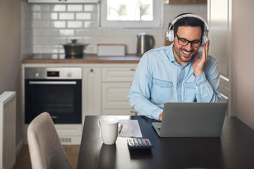 Wall Mural - Businessman with headset having a video call.