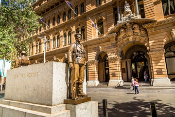 Sydney, Australia - 10th February 2020: A german photographer visiting the city center, taking pictures of a historic building with monuments in front of it.