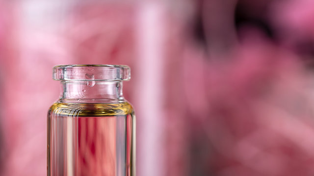 Fototapete -  - Blend of essential oils closeup. Making some aroma liquids, perfume. Drops falling from pippet to little glass bottle. Liquid ingredients, body care production, cosmetology.