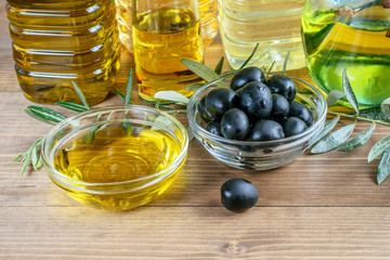 Wall Mural - Aseytunas in glass transparent bowl and assortment of olive oil . Healthy diet food concept.