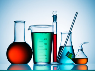Wall Mural - different laboratory glassware with color liquid and with reflection