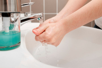 Washing hands with soap under the faucet with water for coronavirus prevention, hygiene to stop spreading coronavirus. Hygiene concept, Hygiene sanitary, clean, wash, disinfect hygienic human.