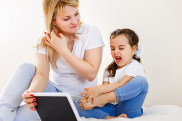 Canvas Print - Mom and daughter using tablet