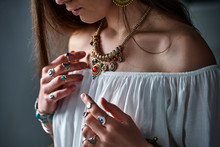 Stylish Boho Chic Woman Wearing White Blouse With Golden Necklace And Silver Rings. Fashionable Indian Hippie Gypsy Bohemian Outfit With Imitation Jewelry Details Accessories