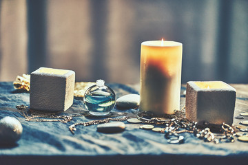 Wall Mural - Group of magic burning candles and a bottle elixir potion for a divination occult spell witchcraft ritual and scary halloween rite