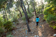 © zhukovvvlad - A woman runs along a mountain trail.