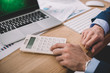© LIGHTFIELD STUDIOS - Cropped view of data analyst using calculator near laptop and papers on table