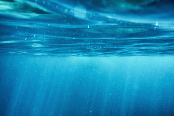 surface ripple underwater blue ocean with sunray in tropical sea