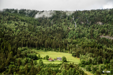 Wall Mural - waterfall and tiny village in the countryside of norway