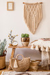 © FollowTheFlow - Stylish composition of living room interior with mock up frame, wooden bench, pillow, plaid, woman bag, books, cacti, macrame, plant, decortaion and elegant personal accessories in modern home decor.