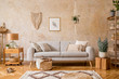 © FollowTheFlow - Stylish scandi compostion at living room interior with design gray sofa, wooden coffee table, shelf, cube, carpet, rattan pouf, plants, picture frame, table lamp and elegant accessories in home decor.